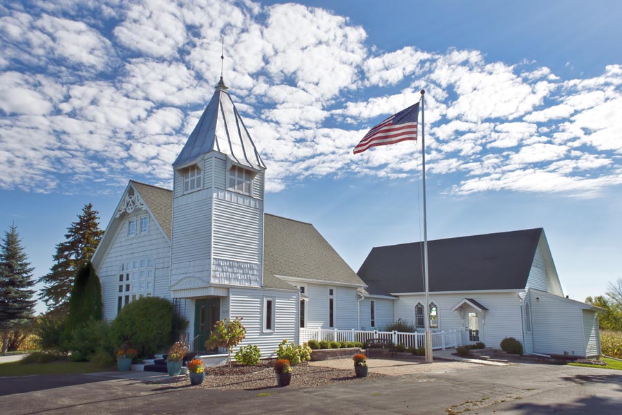 Specialized Business Insurance - Rural American Church with an American Flag Outside